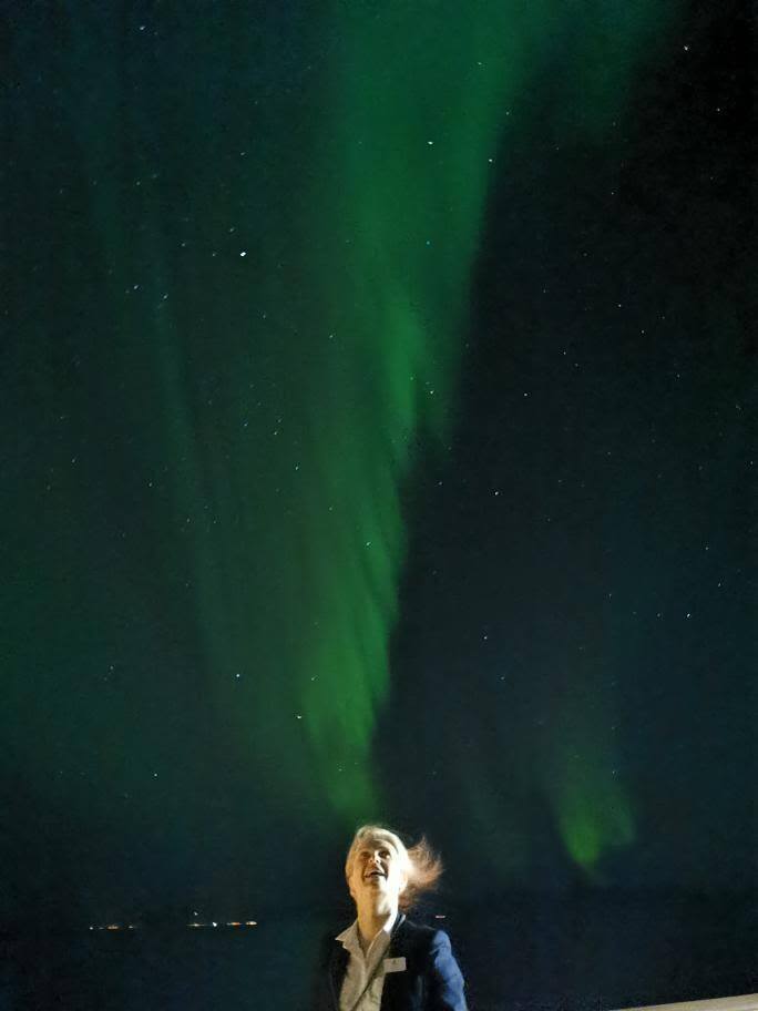 Employee of Havila Voyages under the Northern Lights