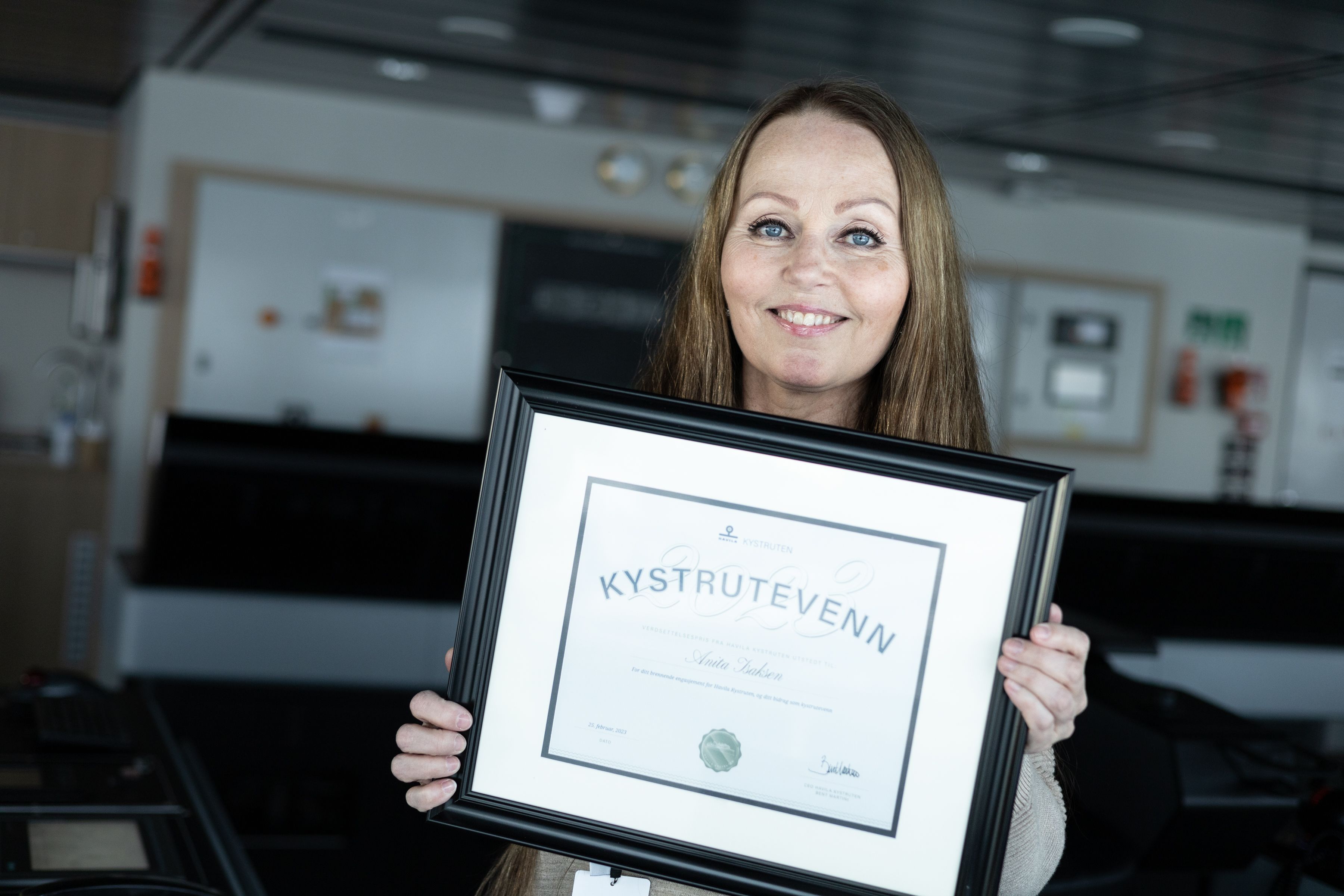 Anita showing her diploma